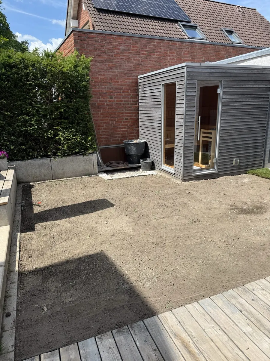Garten vor der Rasenanlage: vorbereitete, planierte Erdfläche an Terrasse und Gartenhaus